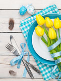 Easter with yellow tulips and colorful eggs