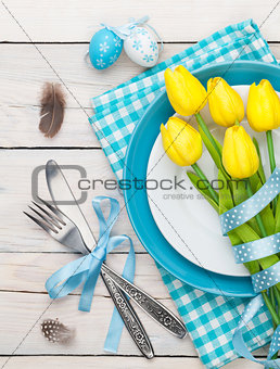 Easter with yellow tulips and colorful eggs