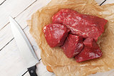 Raw fillet beef steak pieces and kitchen knife