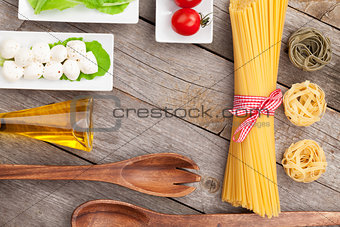Tomatoes, mozzarella, pasta and green salad leaves