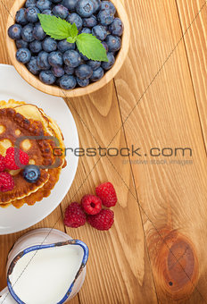 Pancakes with raspberry, blueberry and milk