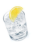 Glass of pure water with ice cubes and lemon slice