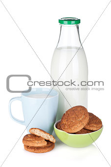 Cup, bottle of milk and bowl with cookies