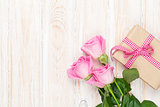 Valentines day background with pink roses over wooden table and 