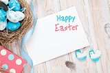 Easter greeting card with blue and white eggs and gift box over 