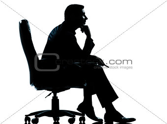 one business man sitting in armchair silhouette