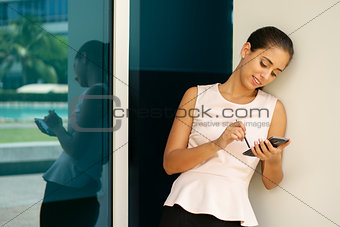 Happy Business Woman Typing With Pen On Smartphone