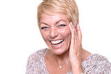Laughing Blond Adult Woman Touching her Face