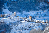 Mountain village on the snowy slope in Caucasus