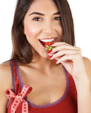 Healthy woman eating strawberry