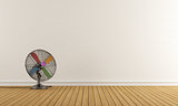 Empty room with colorful fan