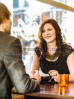 Couple enjoying cappuccino at the restaurant