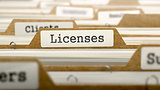 Licenses Concept with Word on Folder.