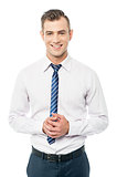 Corporate man posing with clasped hands