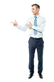 Young businessman pointing copyspace
