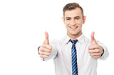 Smiling business executive with thumbs up