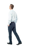 Businessman walking forward, hands in pocket