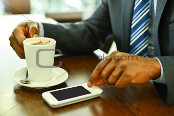 Man using mobile phone in the coffee shop
