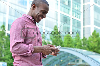 Smiling man using his cell phone