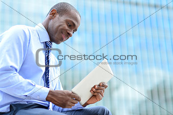 Smiling corporate executive using a tablet pc