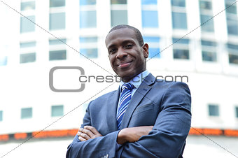 Confident businessman with arms crossed