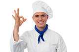 Young male chef showing ok sign