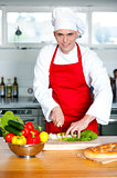 Chef chopping vegetables in kitchen