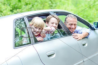 Father enjoying car drive with his kids
