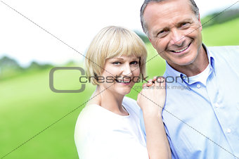 Affectionate couple smiling at camera