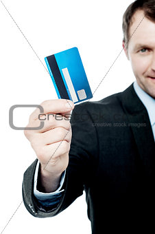 Smiling businessman holding credit card