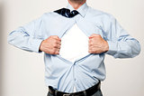 Businessman pulling his t-shirt open