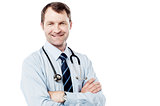 Male doctor standing with folded arms