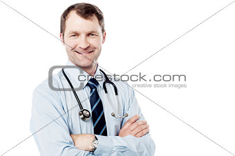 Male doctor standing with folded arms