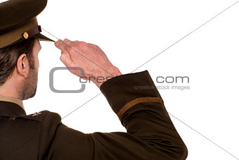 Rear view of male army soldier saluting