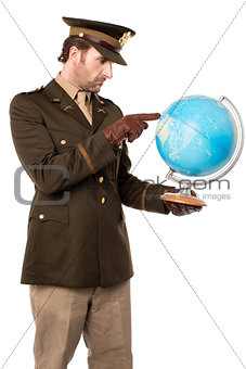 Military officer pointing the globe