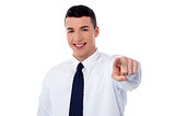 Young corporate guy pointing at you