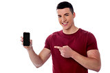 Smiling man displaying his mobile phone