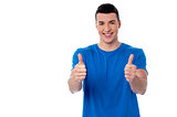 Young smiling man showing thumbs up