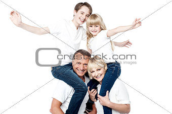 Playful family of four isolated over white