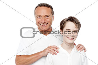 Cheerful mature father and son posing