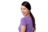 Smiling woman looking over shoulder