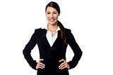 Smiling businesswoman with hands on hips
