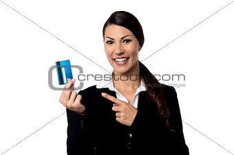Smiling woman holding up credit card