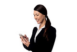 Smiling businesswoman using mobile phone