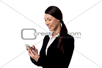 Smiling businesswoman using mobile phone