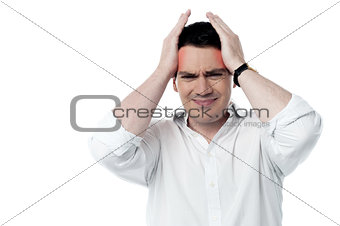 Stressed man having strong headache