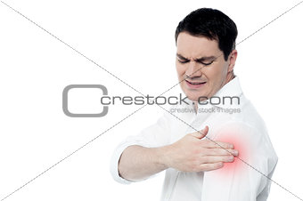 Young man suffering from shoulder pain