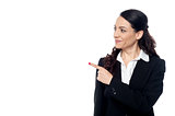 Young female executive pointing at something