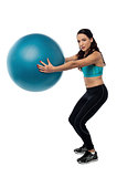 Woman worksout with fitness ball