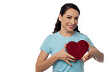 Smiling woman with heart shape gift box
